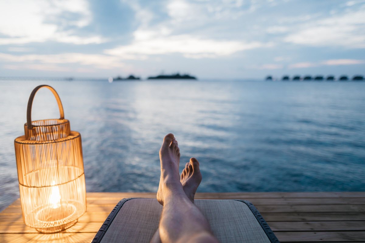 person relaxes by the ocean